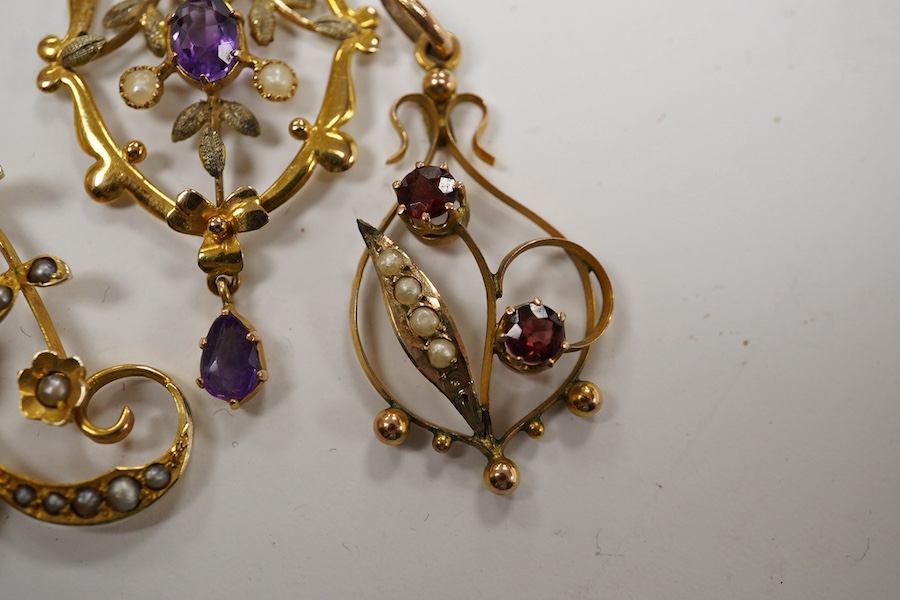 Three assorted early 20th century 9ct and gem set pendants, largest 53mm, gross weight 6.4 grams. Condition - poor to fair